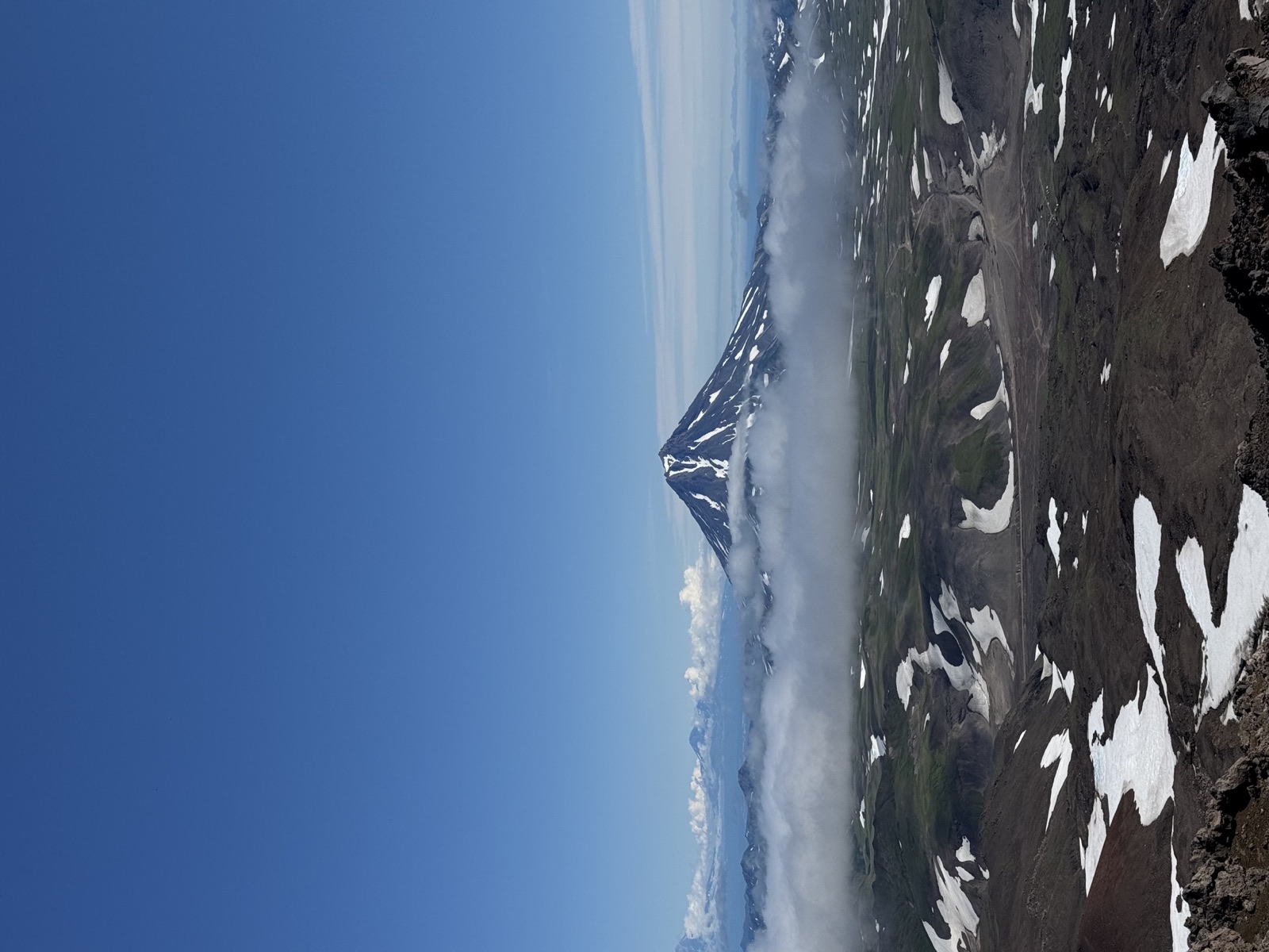 A volcano rising above clouds in Kamchatka